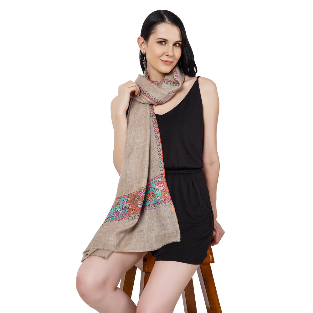 A young woman wearing hand embroidered pashmina scarves