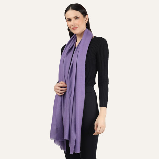 Woman wearing a purple cashmere scarf over a black dress
