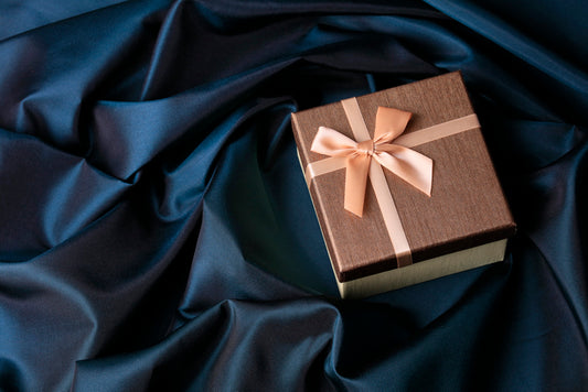 A Luxurious gift box on a velvet cloth with a gift ribbon