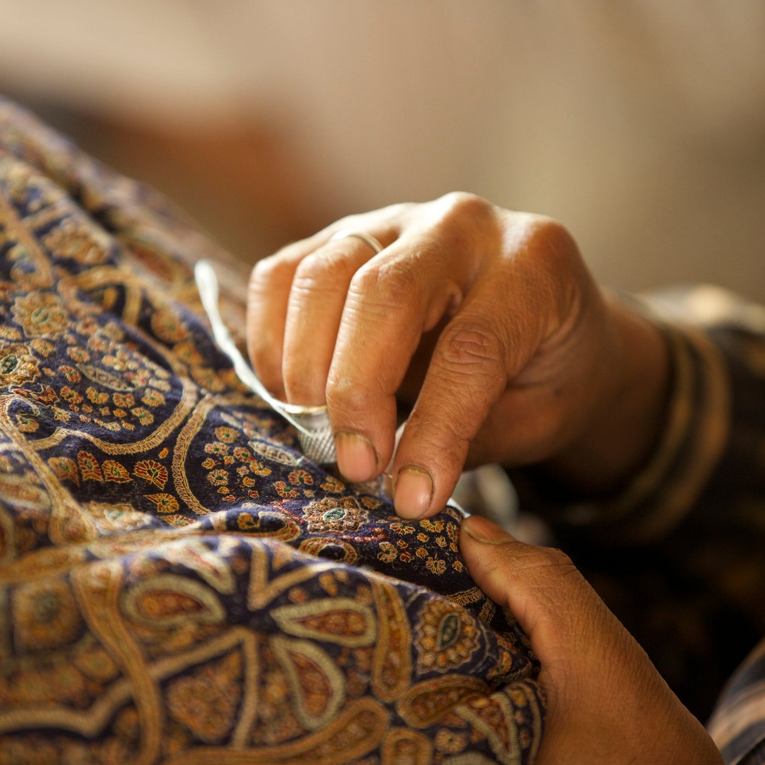 Kashmiri Artisan doing sozni embroidery on a Cashmere Pashmina Shawl 