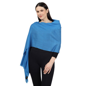 A woman wearing a Blue Cashmere Scarf on a black dress