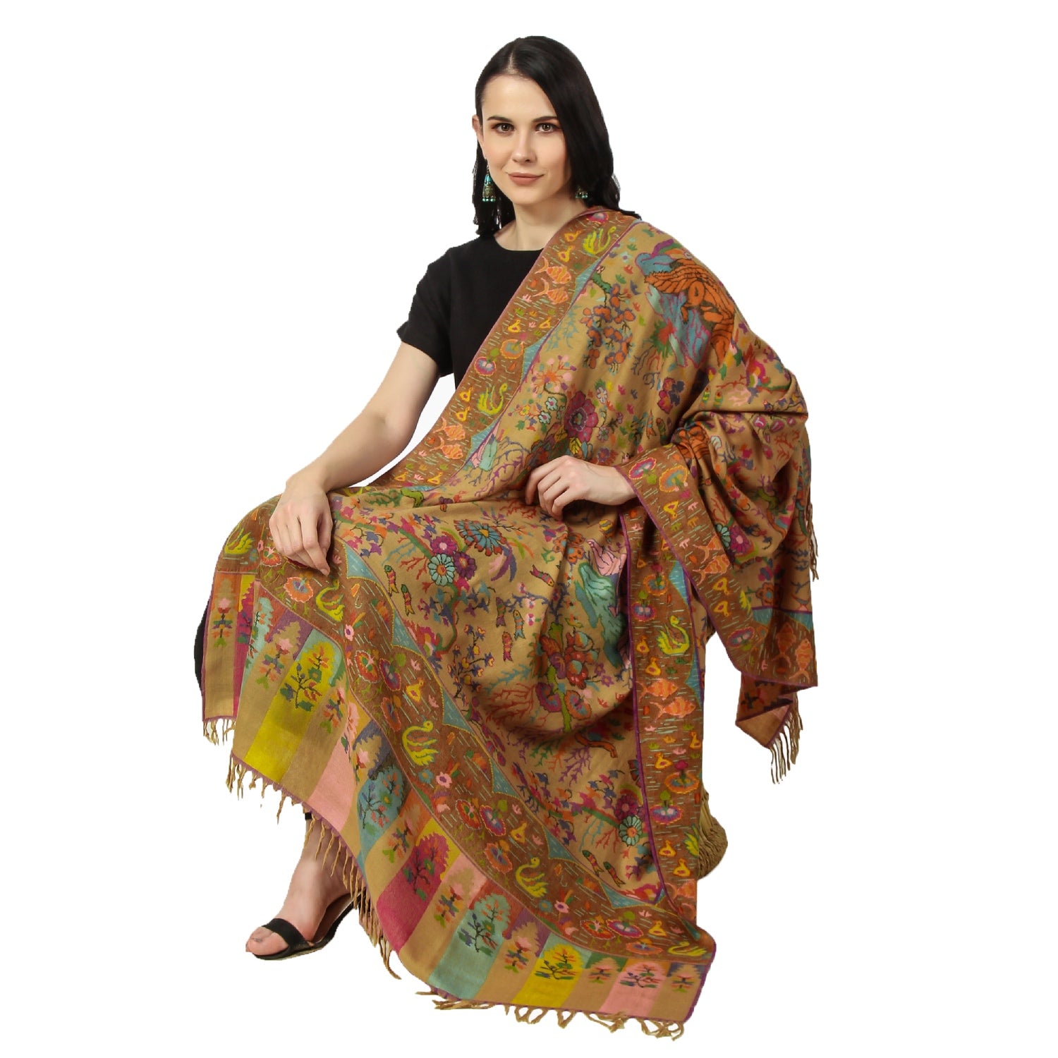 A woman wearing Kani Pashmina shawl while sitting on a chair wearing black dress.