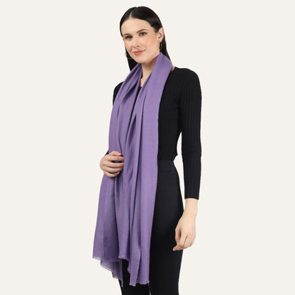 Woman wearing a purple cashmere scarf over a black dress