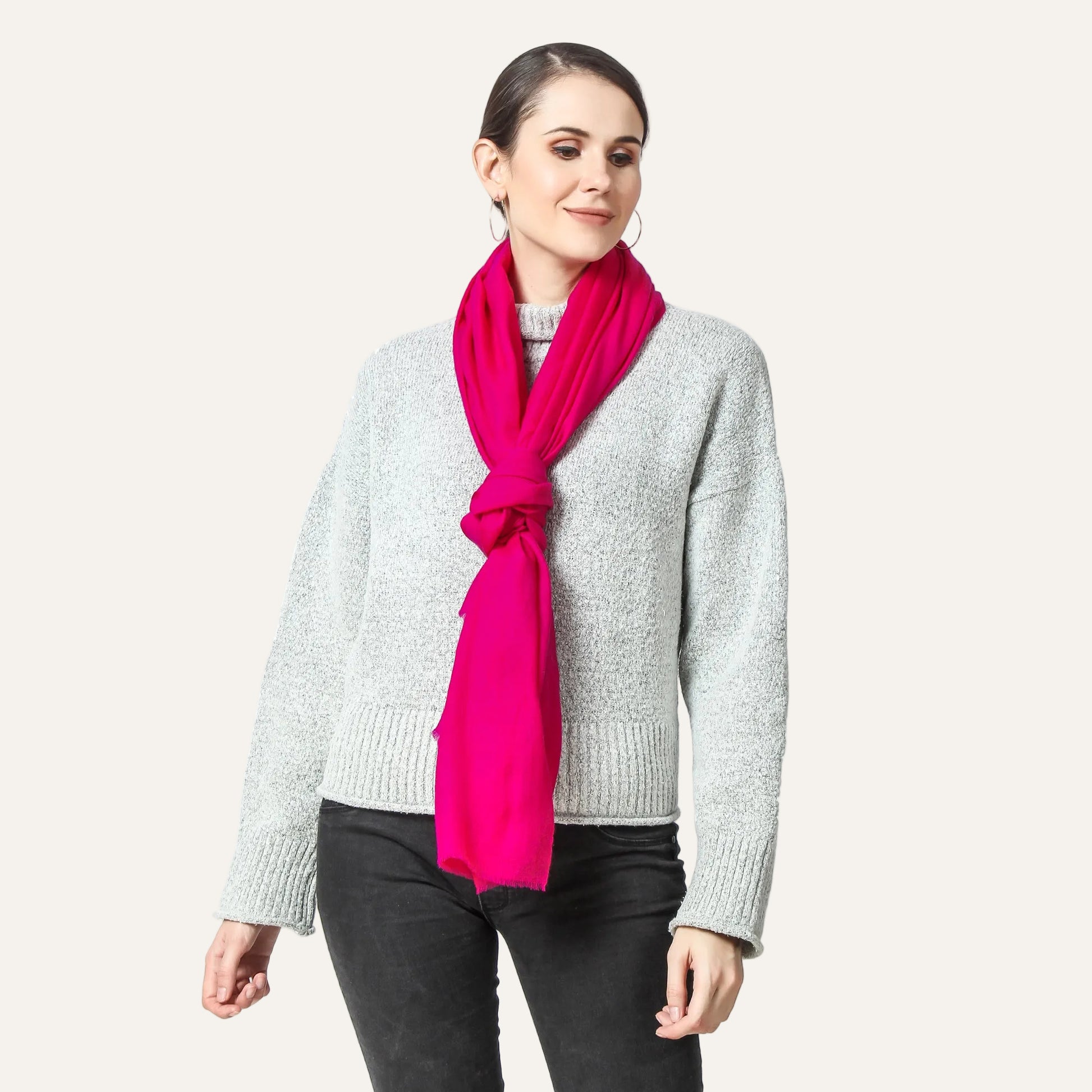 Woman wearing a Fuchsia color Cashmere scarf over a gray sweater