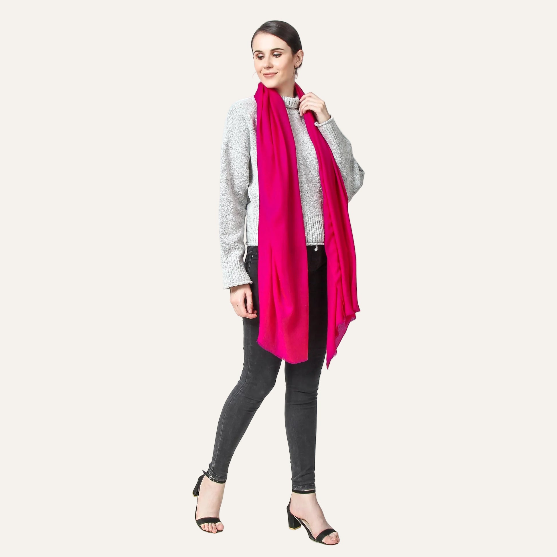 Fuscia Cashmere Scarf draped by a woman over her neck