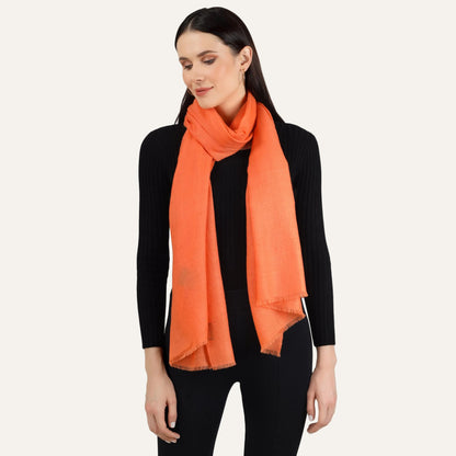 orange scarf draped by woman around her neck
