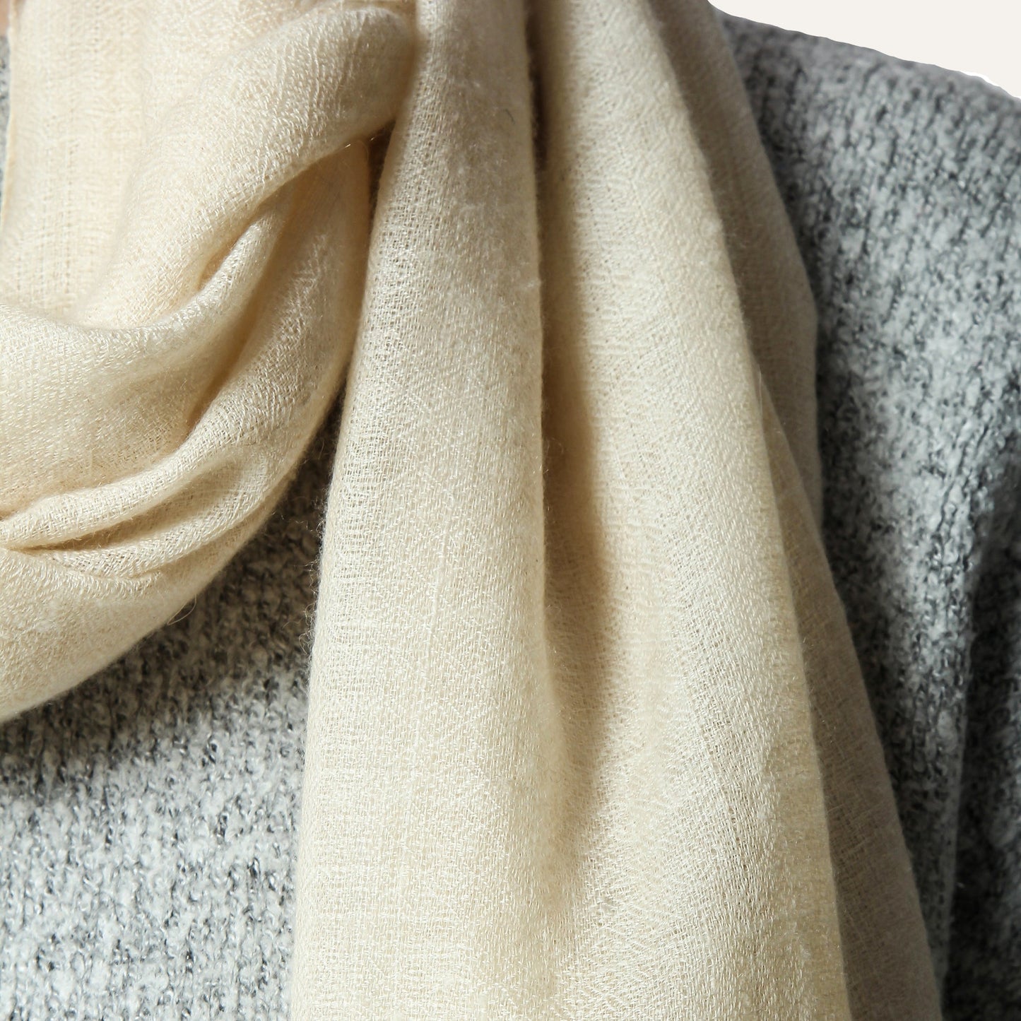 woman wearing premium cashmere scarf and the picture has been taken of cashmewre scarf only in closeup