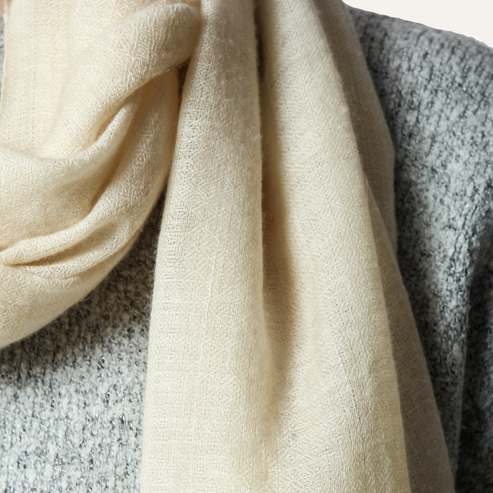 woman wearing premium cashmere scarf and the picture has been taken of cashmewre scarf only in closeup