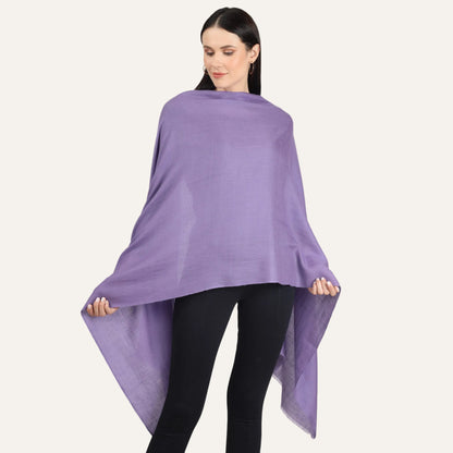A woman wearing a purple cashmere scarf draped over her shoulders.