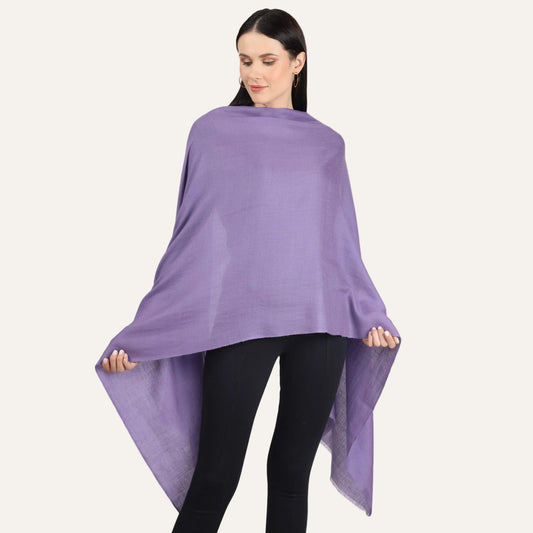 A woman wearing a purple cashmere scarf draped over her shoulders.