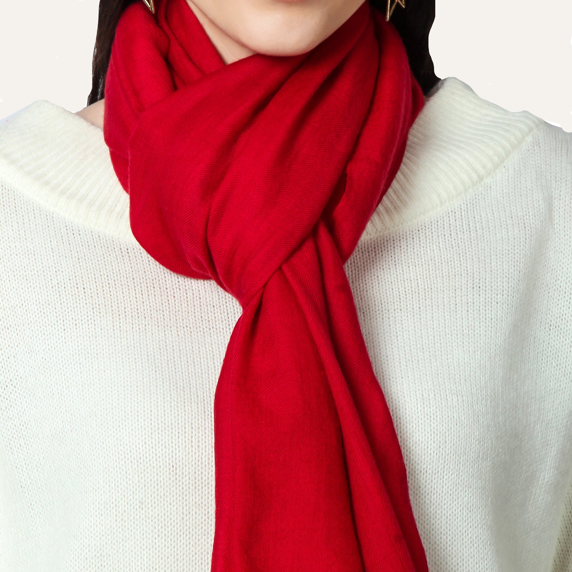 Red scarf worn by a person on a white background