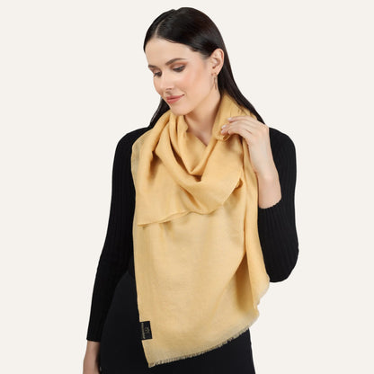 A woman wearing a yellow scarf on a black dress
