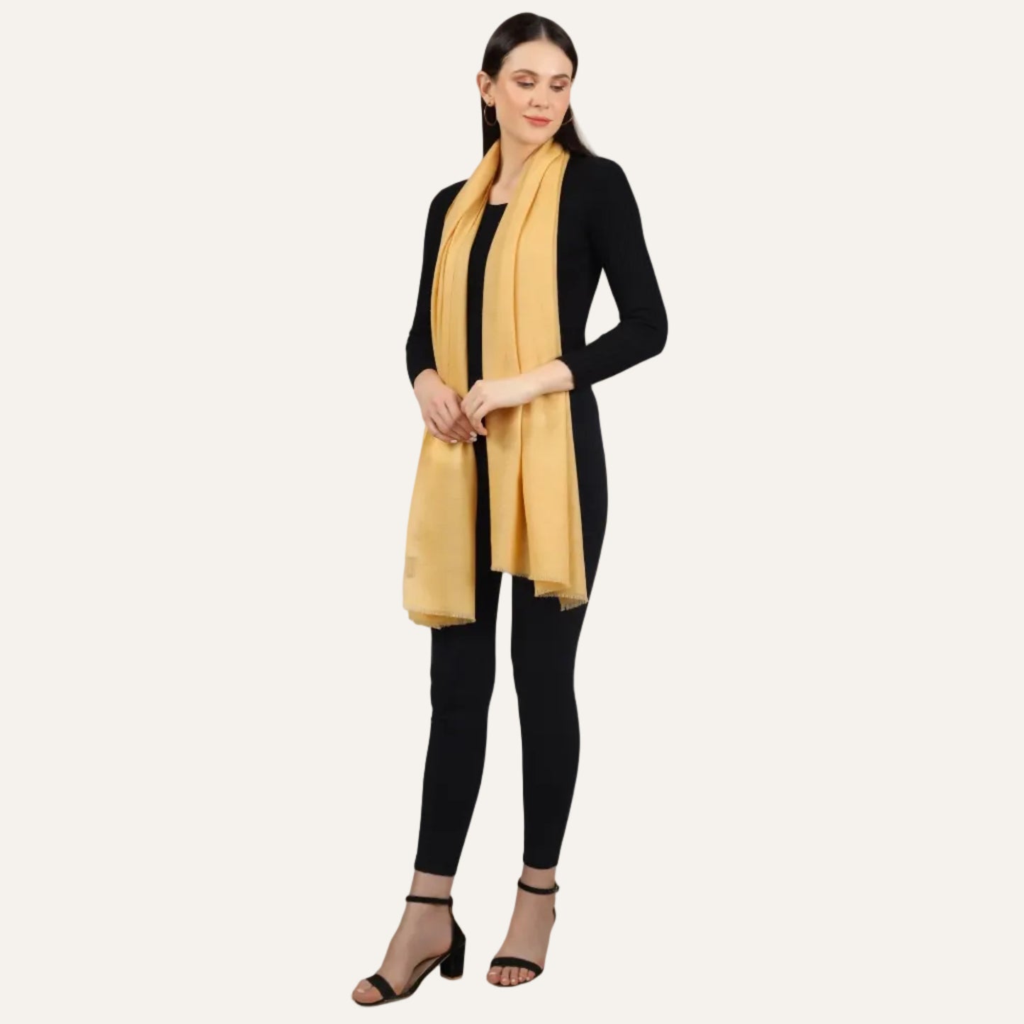 Woman wearing a yellow scarf over a black dress