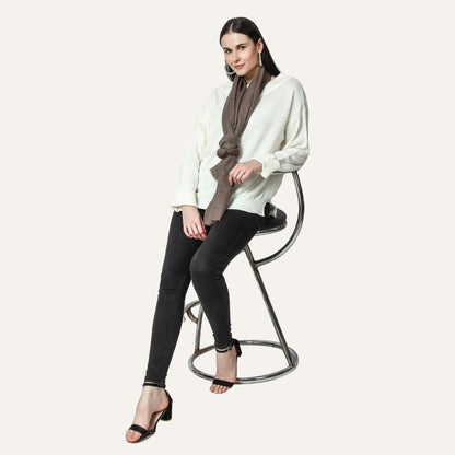 Merlin cashmere scarf for women sitting on a stool